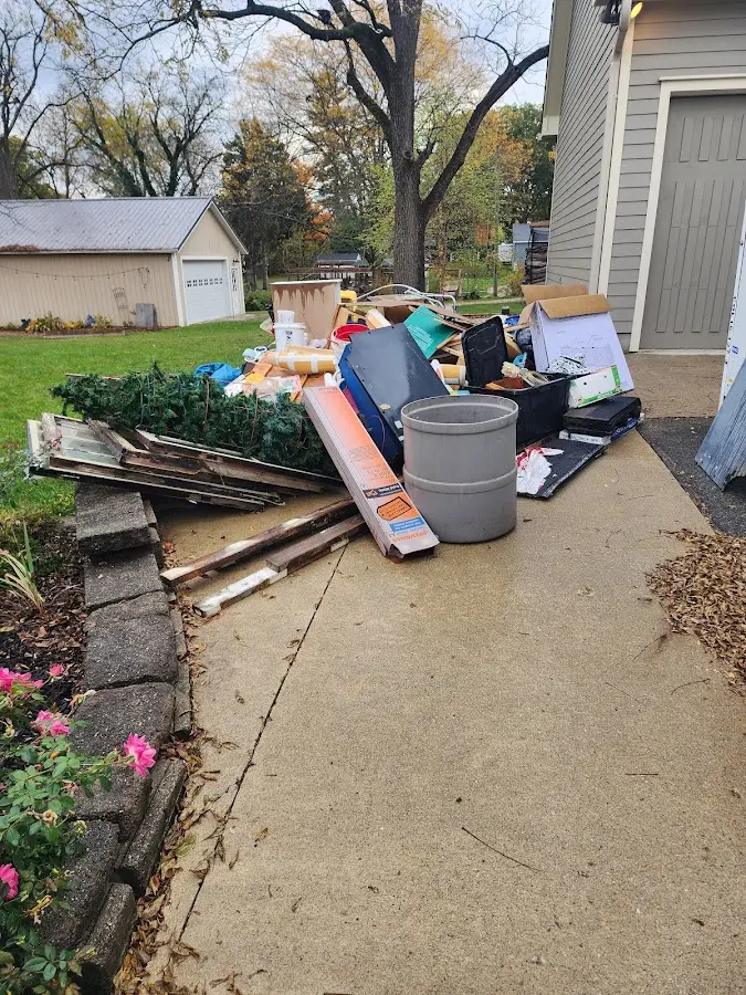 Dumpster being loaded with debris for Estate Cleanout Dumpster Rental in Hartford